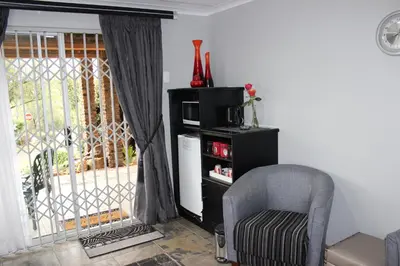 a living room with a chair and a window at Waterfront Guest House in Carolina