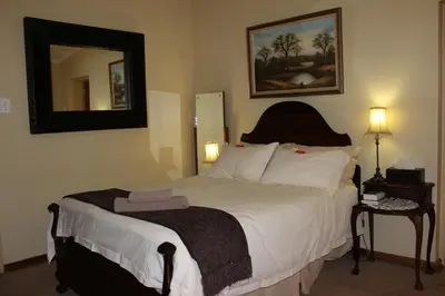 a bedroom with a large bed with a mirror at Waterfront Guest House in Carolina