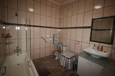 a bathroom with a sink and a toilet and a tub at Waterfront Guest House in Carolina