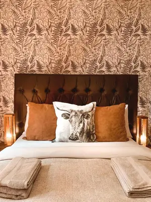 a bed with a picture of a cow on it at Lush in Graskop