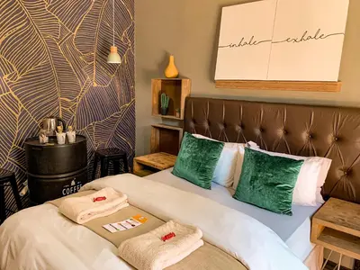 a hotel room with two beds with towels on them at Lush in Graskop