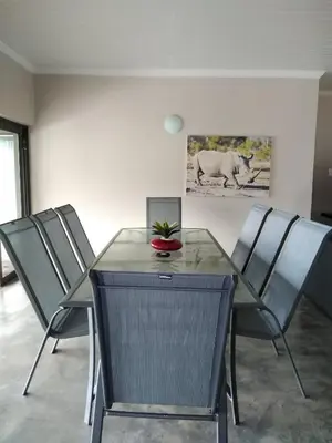 a dining room with a table and chairs at Hazyview Bogarts Villa in Hazyview
