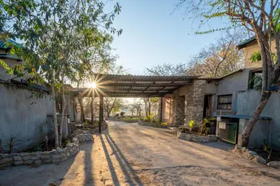 a dirt road in front of a building at Foxy Crocodile Bush Lodge & Kruger Safaris in Marloth Park