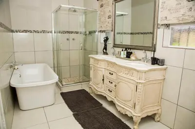 a bathroom with a sink and a shower and a tub at La Vida Luka - Luxury Guesthouse in Pretoria