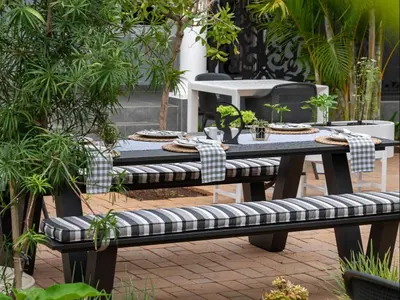 a picnic table and benches with plants on it at Familia Guesthouse & Boutique Hotel in Groblersdal