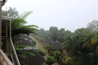 a view of a resort with thatched roofs at Magoebaskloof Mountain Lodge in Magoebaskloof