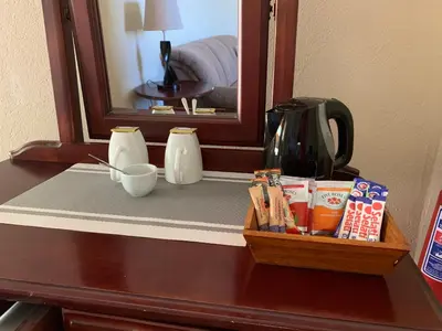 a table with a tray of food and a mirror at Auldstone House in Dullstroom