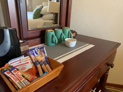 a dresser with a mirror and a table with snacks at Auldstone House in Dullstroom