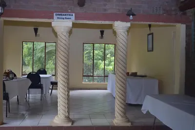 a room with two columns with tables and chairs at Copacopa Lodge and Conference Centre in Punda Maria