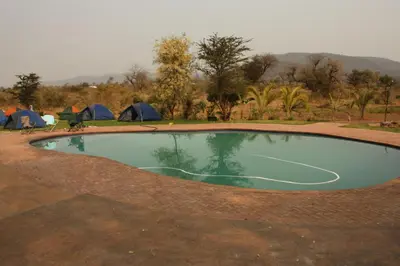 a pool of water with tents in the background at Copacopa Lodge and Conference Centre in Punda Maria