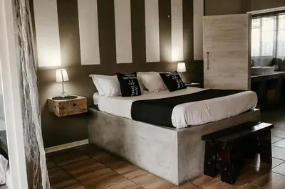 a bedroom with a large bed in a room at Overnight Stop Before Kruger National Park in Phalaborwa