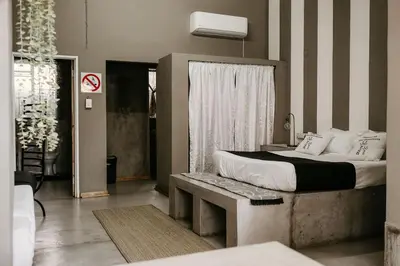 a bedroom with a large bed and a window at Overnight Stop Before Kruger National Park in Phalaborwa