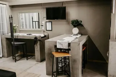 a kitchen with a sink and a counter with a bar at Overnight Stop Before Kruger National Park in Phalaborwa