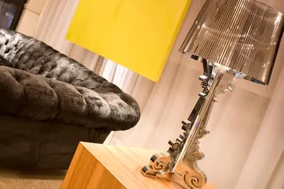 a lamp sitting on a table next to a couch at Manhattan Hotel in Pretoria