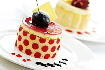 a red polka dot cake on a plate at Manhattan Hotel in Pretoria