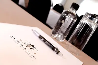 a pen and two glass bottles on a table at Manhattan Hotel in Pretoria
