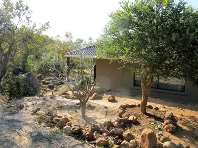 a pile of rocks in front of a house at Ukuthula Hideaway in Kampersrus AH