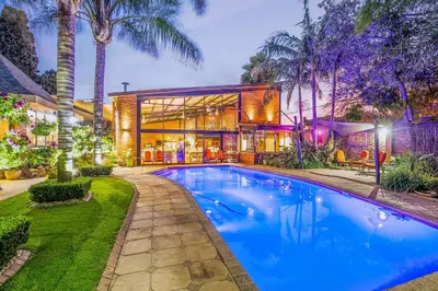 an exterior view of a house with a swimming pool at Sunrock Guesthouse in Kempton Park