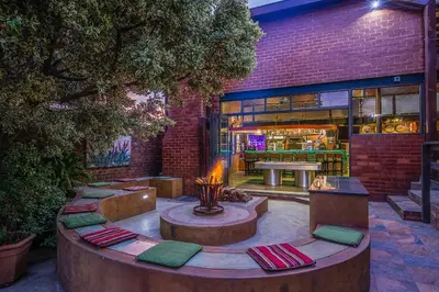 a patio with a fire pit in front of a building at Sunrock Guesthouse in Kempton Park