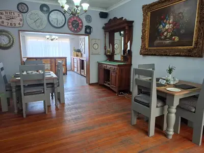 a living room with a table and chairs and a dining room at Sunrock Guesthouse in Kempton Park