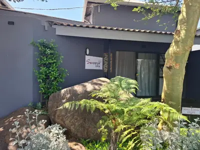 a house with a sign in front of it at Sunrock Guesthouse in Kempton Park