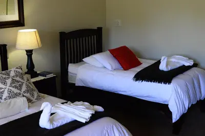 a hotel room with two beds with towels on them at Avant Garde Lodge in Kempton Park