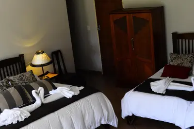 a bedroom with two beds with white towels on them at Avant Garde Lodge in Kempton Park