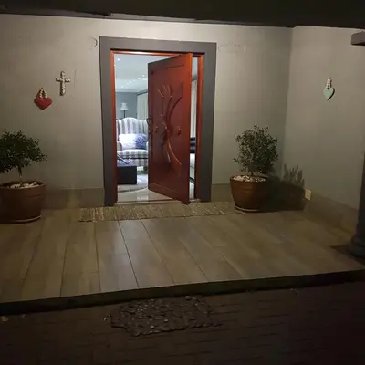 an open door in a room with potted plants at Dinaledi House in Bela-Bela
