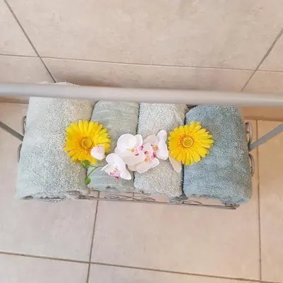 a bunch of towels with flowers on them at Dinaledi House in Bela-Bela