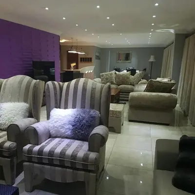 a store with couches and chairs in a room at Dinaledi House in Bela-Bela