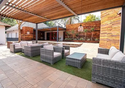 a patio with a bunch of chairs and a table at The Doors Inn in Mokopane