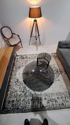 a living room with a table and a lamp at The Doors Inn in Mokopane