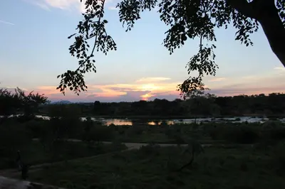 a view of a river at sunset at Buster's River Lodge in Marloth Park