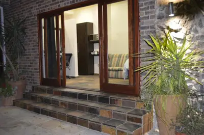 a set of stairs with a mirror and some plants at Birrea Guest house in Polokwane