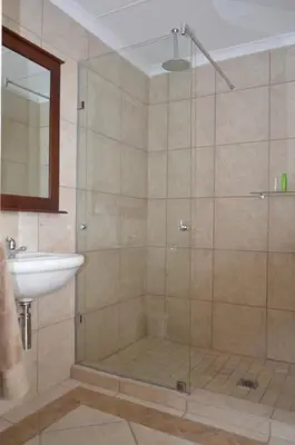 a bathroom with a shower and a sink at Birrea Guest house in Polokwane