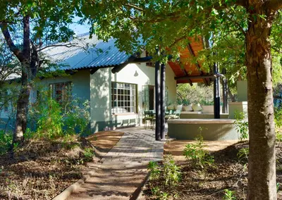 a house with a walkway in front of it at Burchell's Bush Lodge by Dream Resorts in Sabi Sand Game Reserve