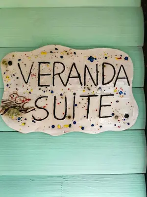 a sign that saysyeraho shuttle on a wooden wall at House of Art in Haenertsburg