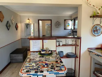 a kitchen with a table with mosaic tiles on it at House of Art in Haenertsburg