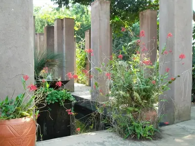 a wooden fence with some plants and flowers at Ku De Ta B&B in White River