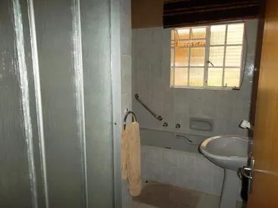 a bathroom with a sink and a toilet and a window at Ku De Ta B&B in White River