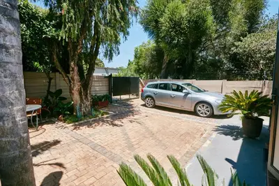 a car parked in a driveway next to a fence at 1202 on Cowgill in Pretoria