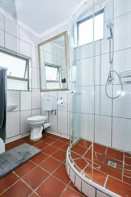 a bathroom with a toilet and a glass shower at 1202 on Cowgill in Pretoria