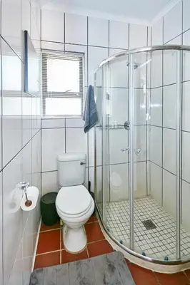 a bathroom with a toilet and a glass shower at 1202 on Cowgill in Pretoria