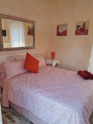 a bedroom with a large bed and a mirror at BellaMaria in Pretoria