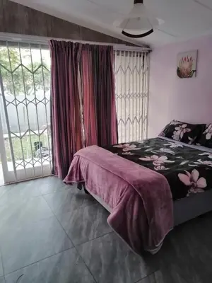 a bedroom with a bed and a large window at BellaMaria in Pretoria