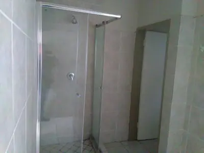 a shower with a glass door in a bathroom at BellaMaria in Pretoria