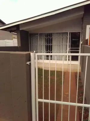 a white fence in front of a house at BellaMaria in Pretoria