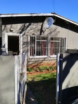 a white fence in front of a house at BellaMaria in Pretoria