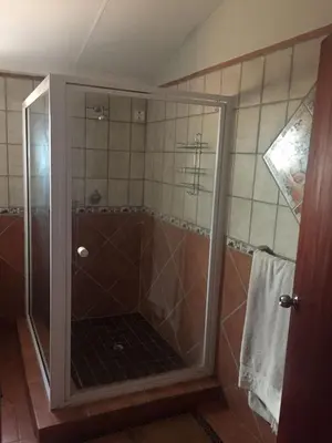 a shower with a glass door in a bathroom at Baobab Lane Lodge in Marnitz