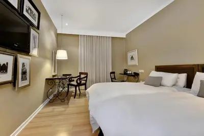 a hotel room with a large bed and a desk at Protea Hotel by Marriott Nelspruit in Nelspruit